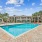 Pet Friendly Apartments in Germantown Nashville TN - The Monroe - Resort-Style Pool with Sun Deck, Lounge Chairs, and View of Building Exterior